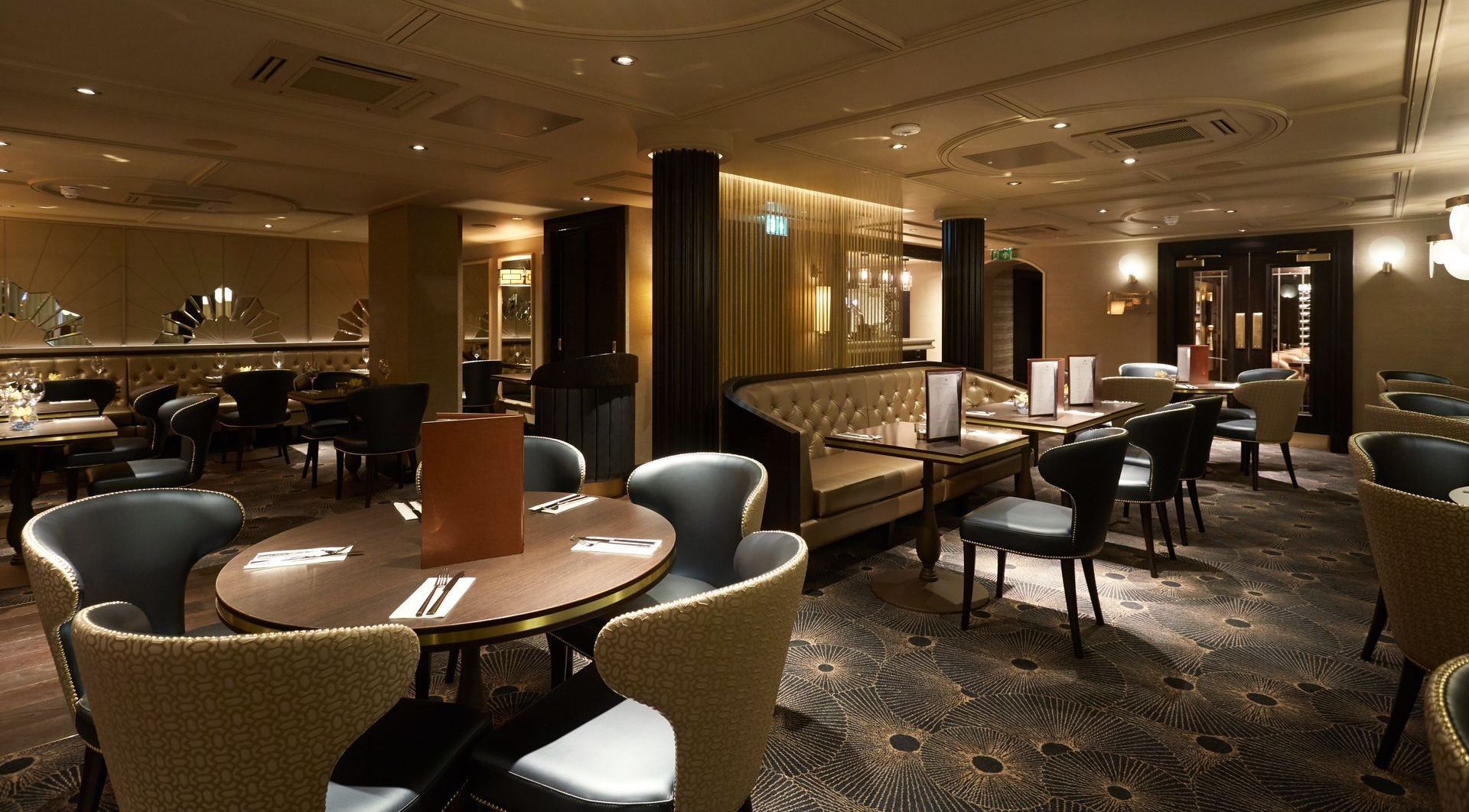 Interior of La Dragon, showing the downstairs with tables, sofas, and chairs