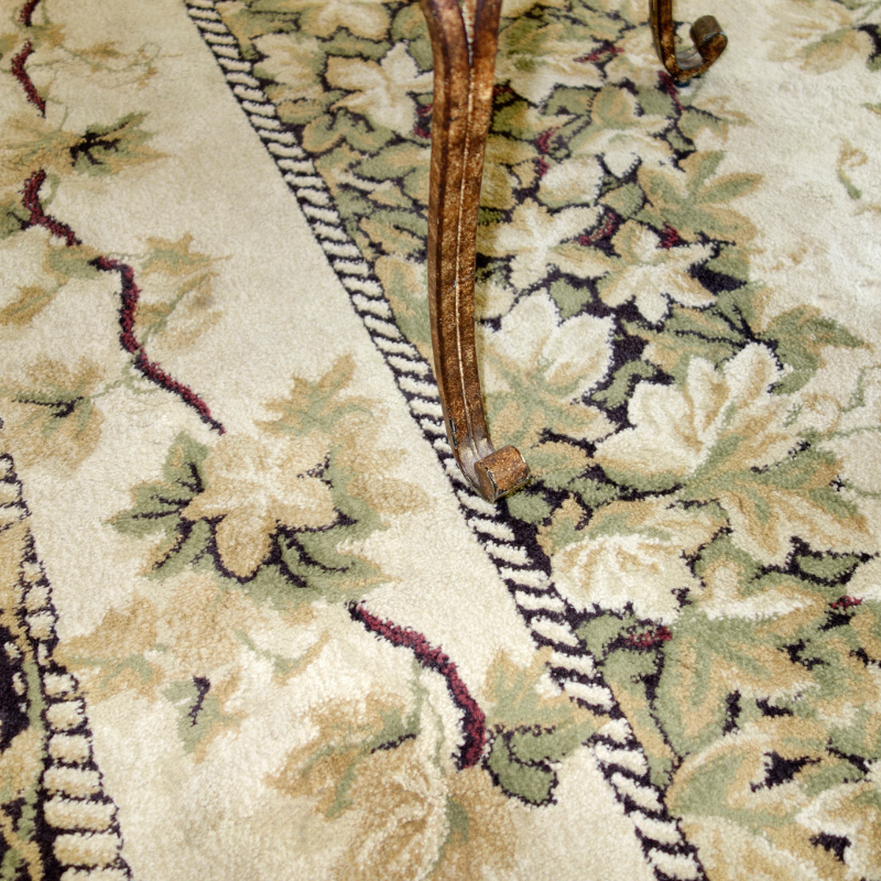 A wool carpet with flowers and leaves design