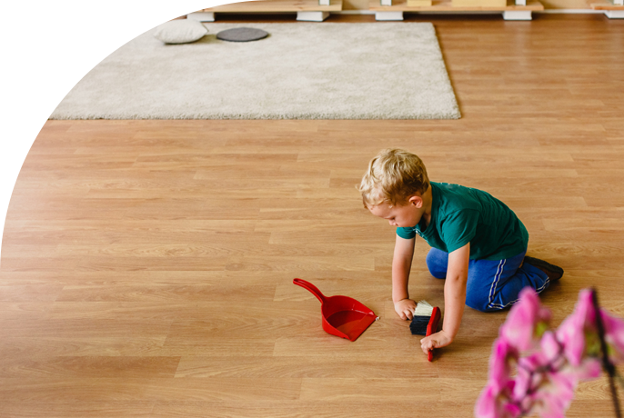 A child sweeping their vinyl living room floor