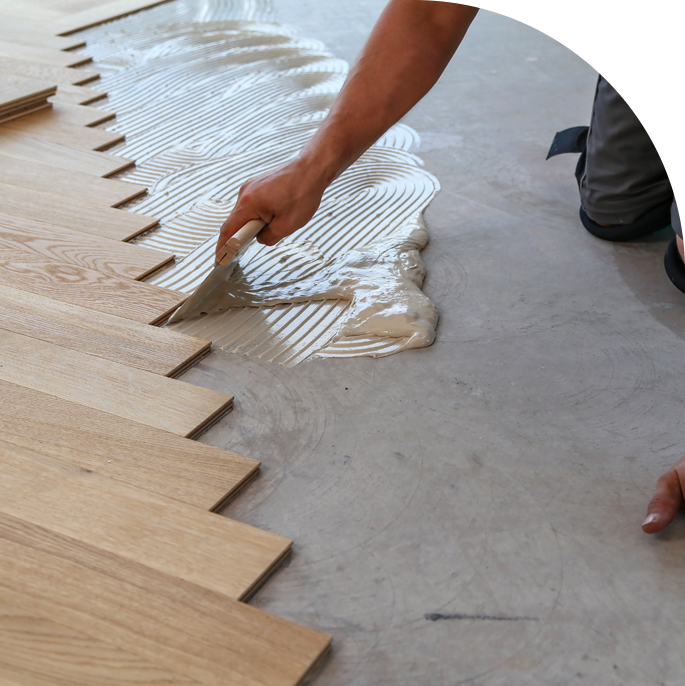 A professional installing laminate floor planks