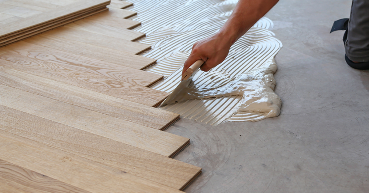 A professional installing laminate floor planks