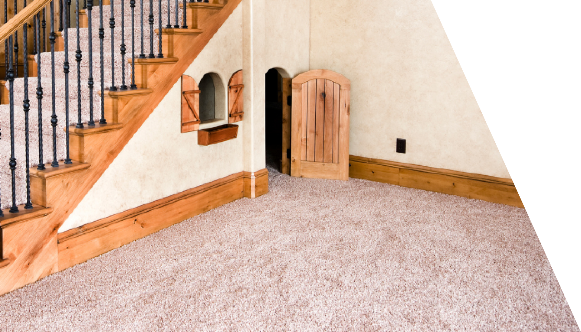 A room with a staircase and a carpeted floor