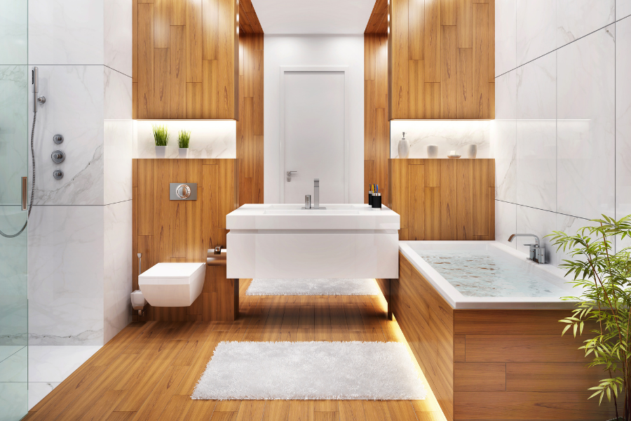 A bathroom installed with hardwood flooring, with a tub , sink , toilet and shower.