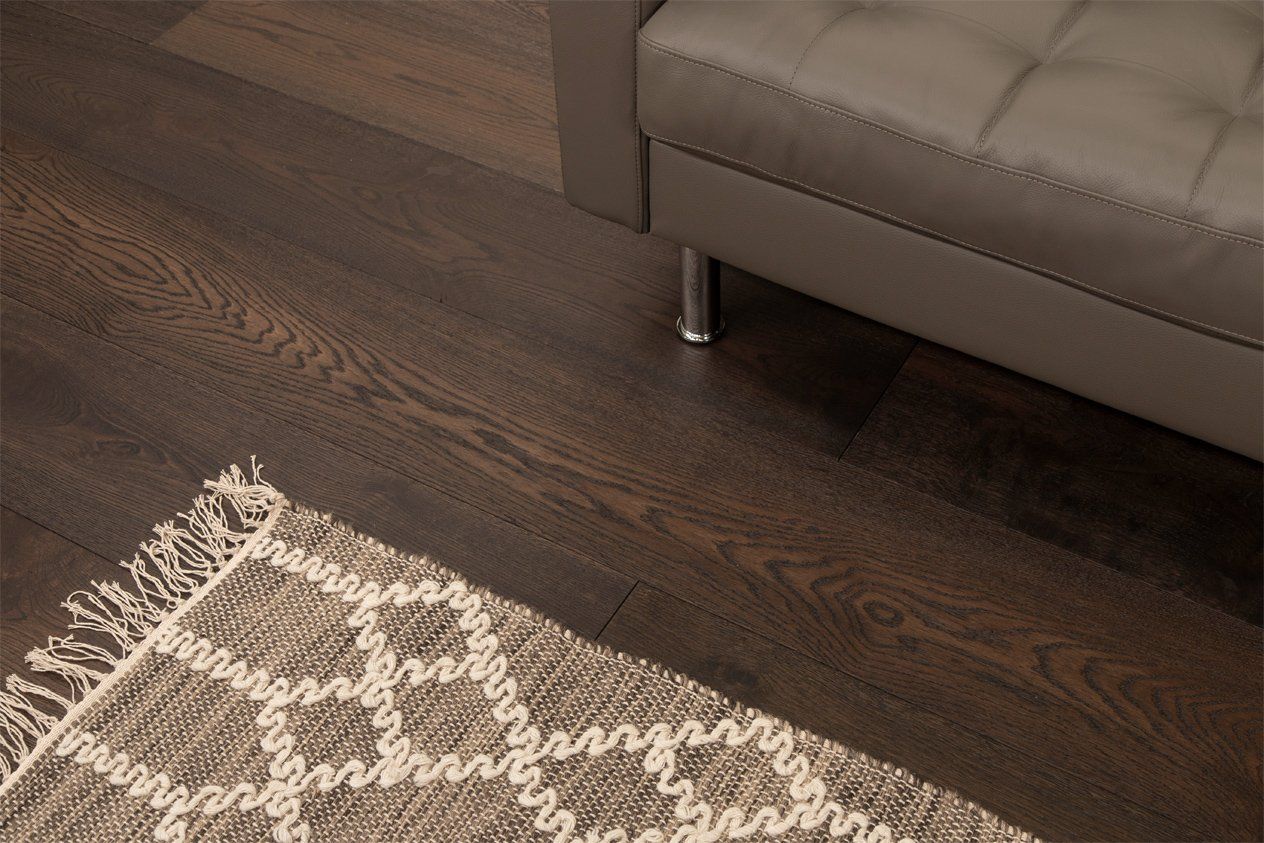 Cali Syrah Oak Hardwood Flooring with a grey rug and sofa