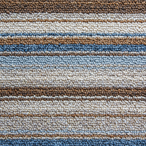 A close up of a striped carpet with blue and brown stripes.