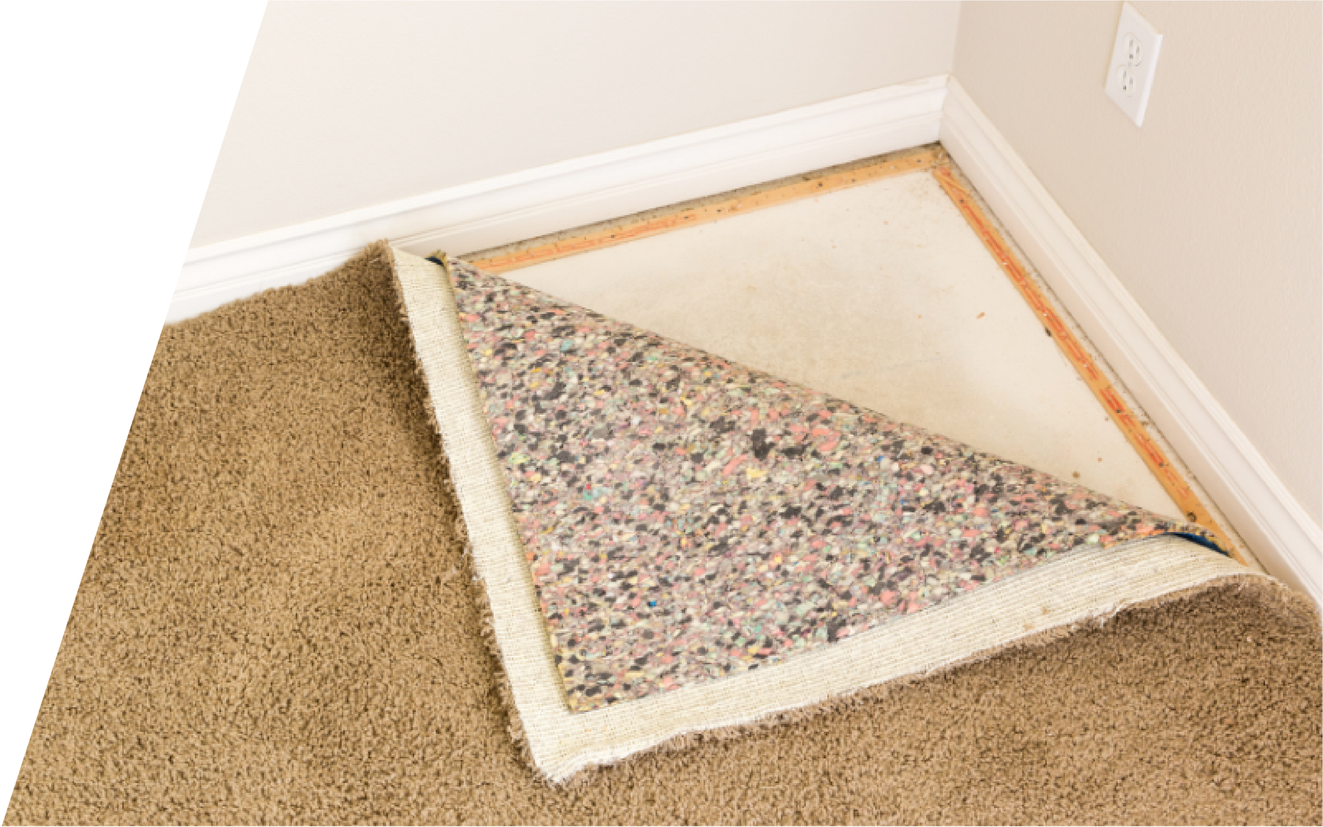 A piece of carpet is sitting in a corner of a room.