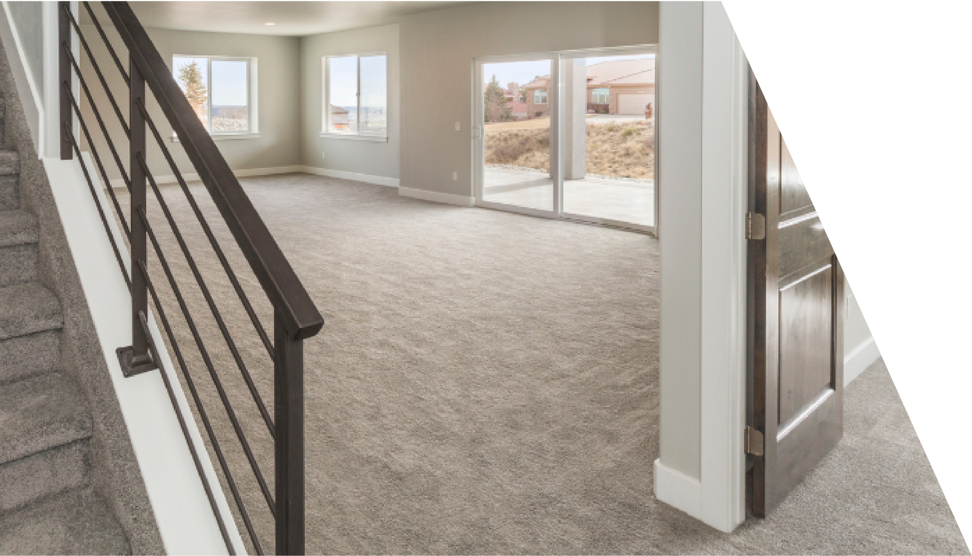 There is a staircase with carpet leading up to the second floor of a house.