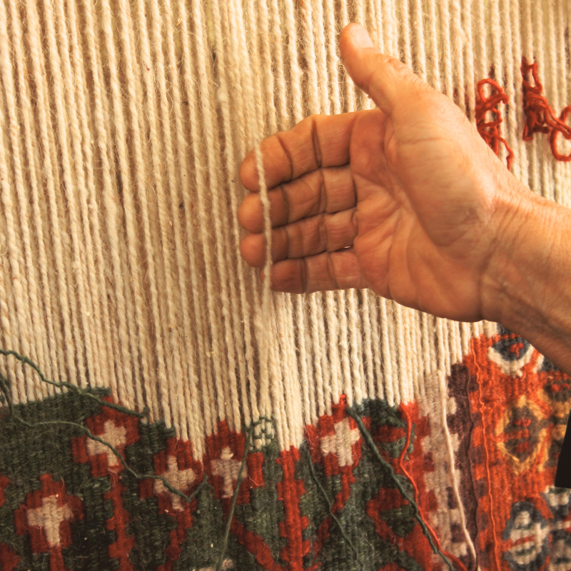 A close up of a person 's hand holding yarn