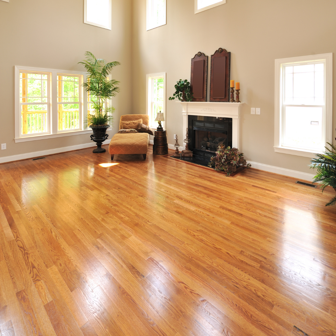 A living room with hardwood floors and a fireplace.