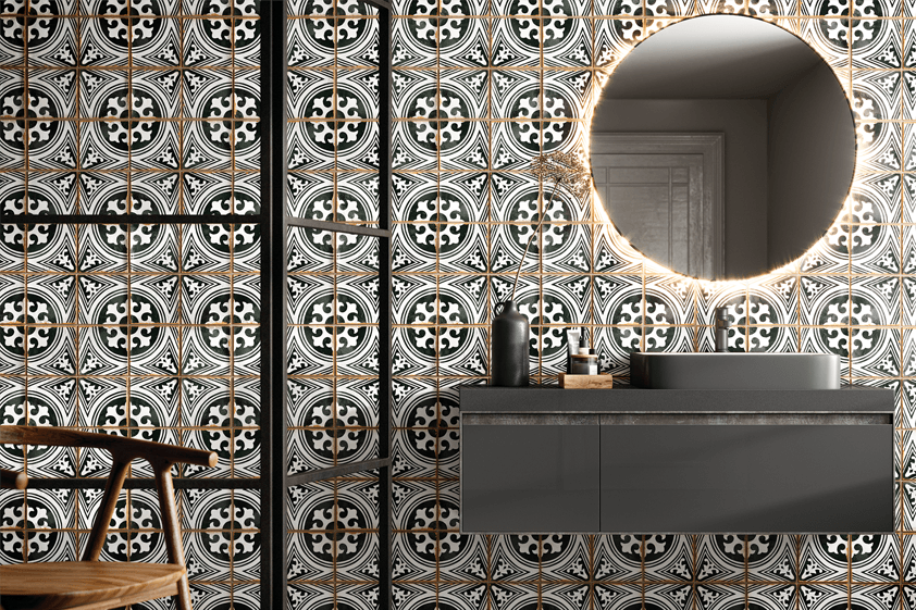 Patterned tiles on a bathroom wall with a circle mirror