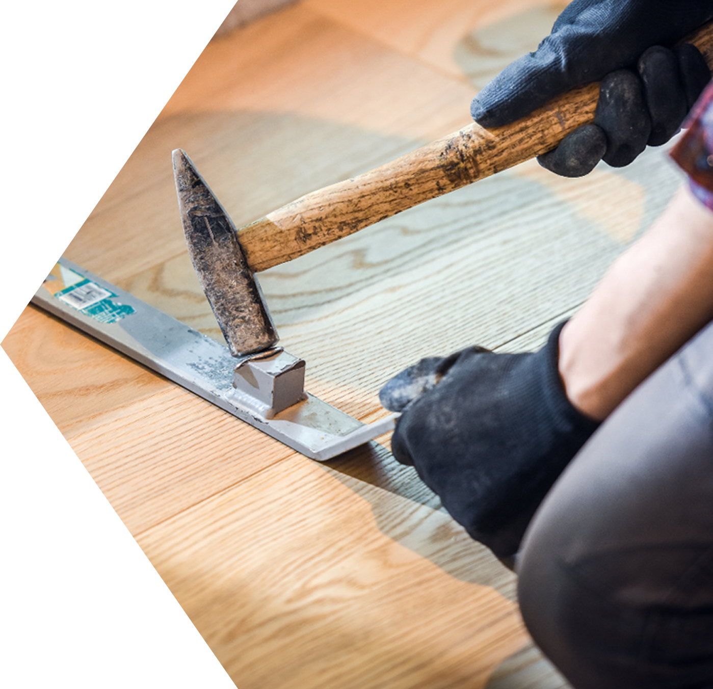 Professional floorsmith skillfully installing wood floors