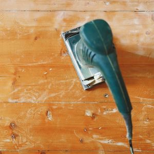 Hand sander on light hardwood floors