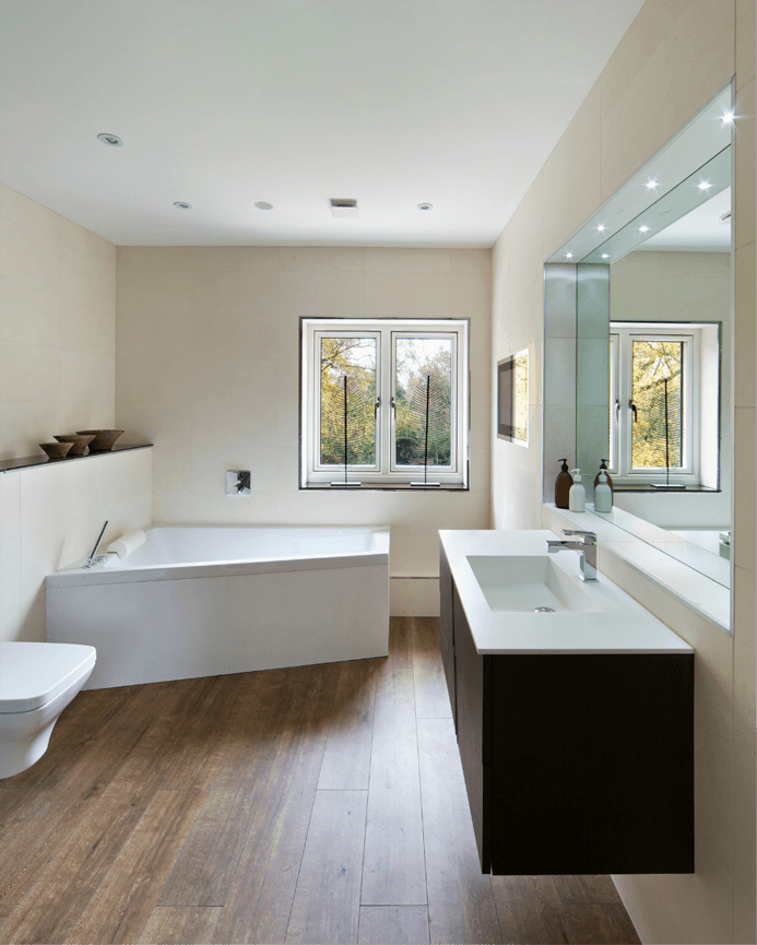 Wood texture laminate bathroom floor with a white tub