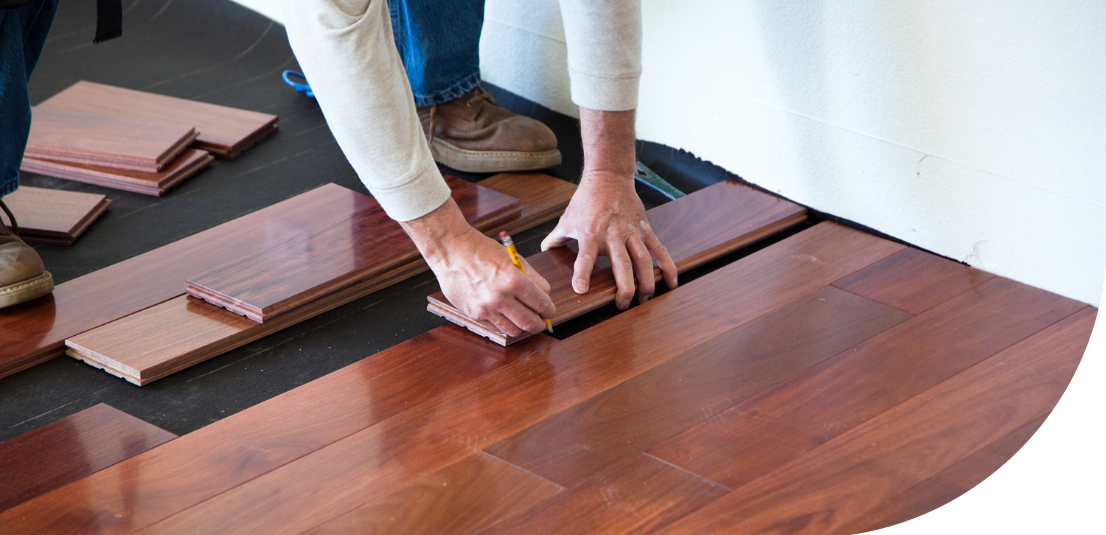 worker installing hardwood floor