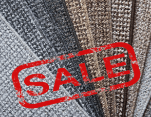 sale text over pile of carpets