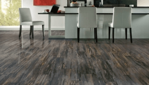 hardwood flooring in a the kitchen with three white chairs