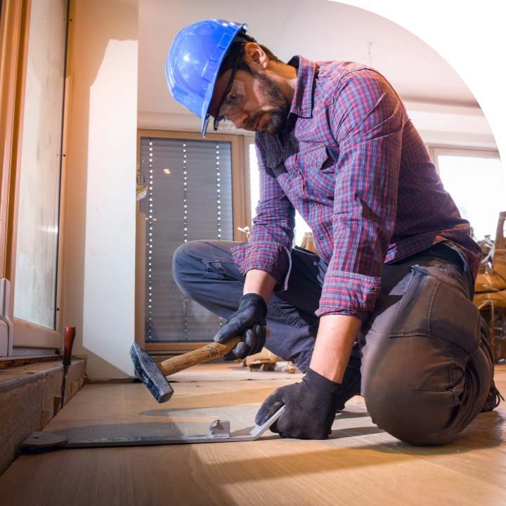 worker installing a hardwood floor