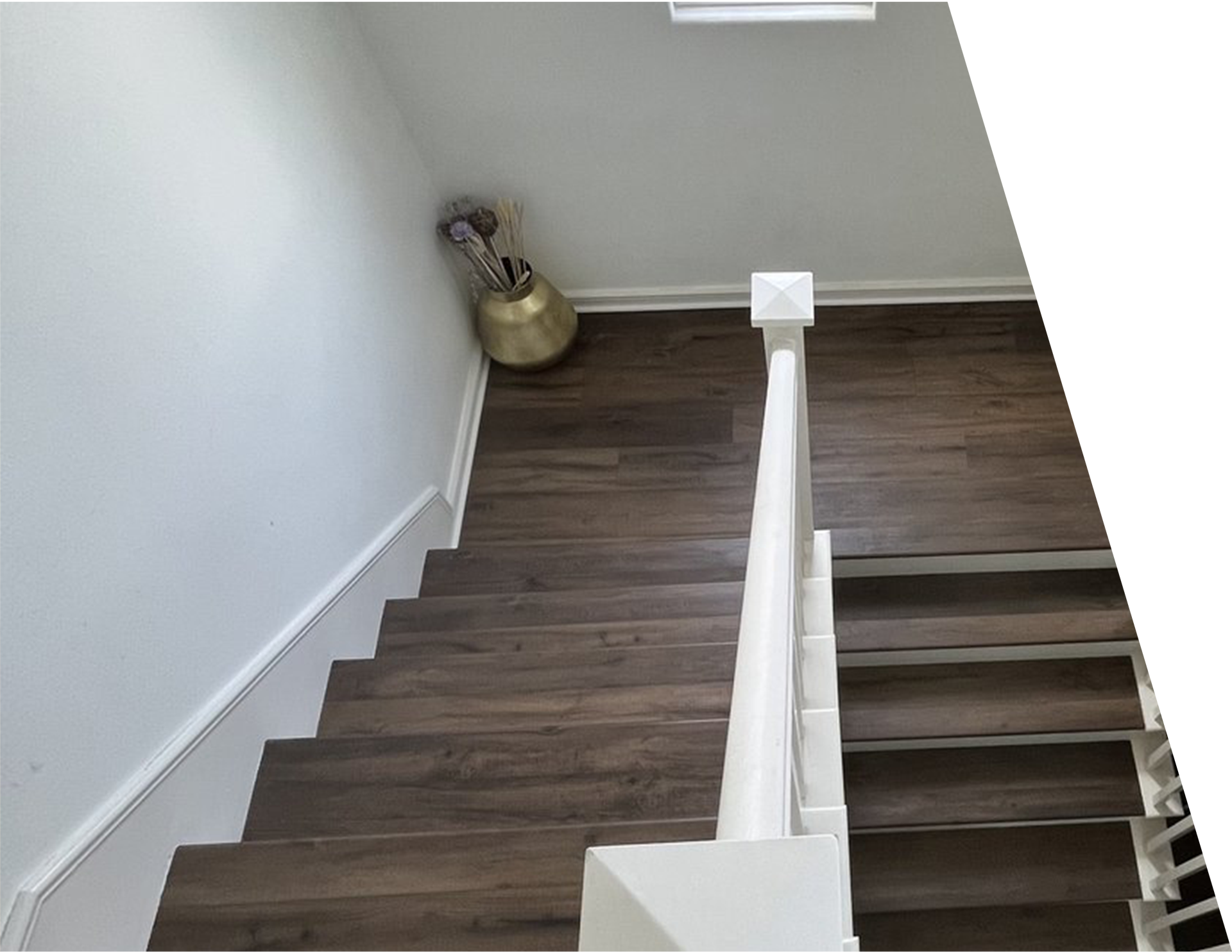 A staircase with wooden steps and a white railing