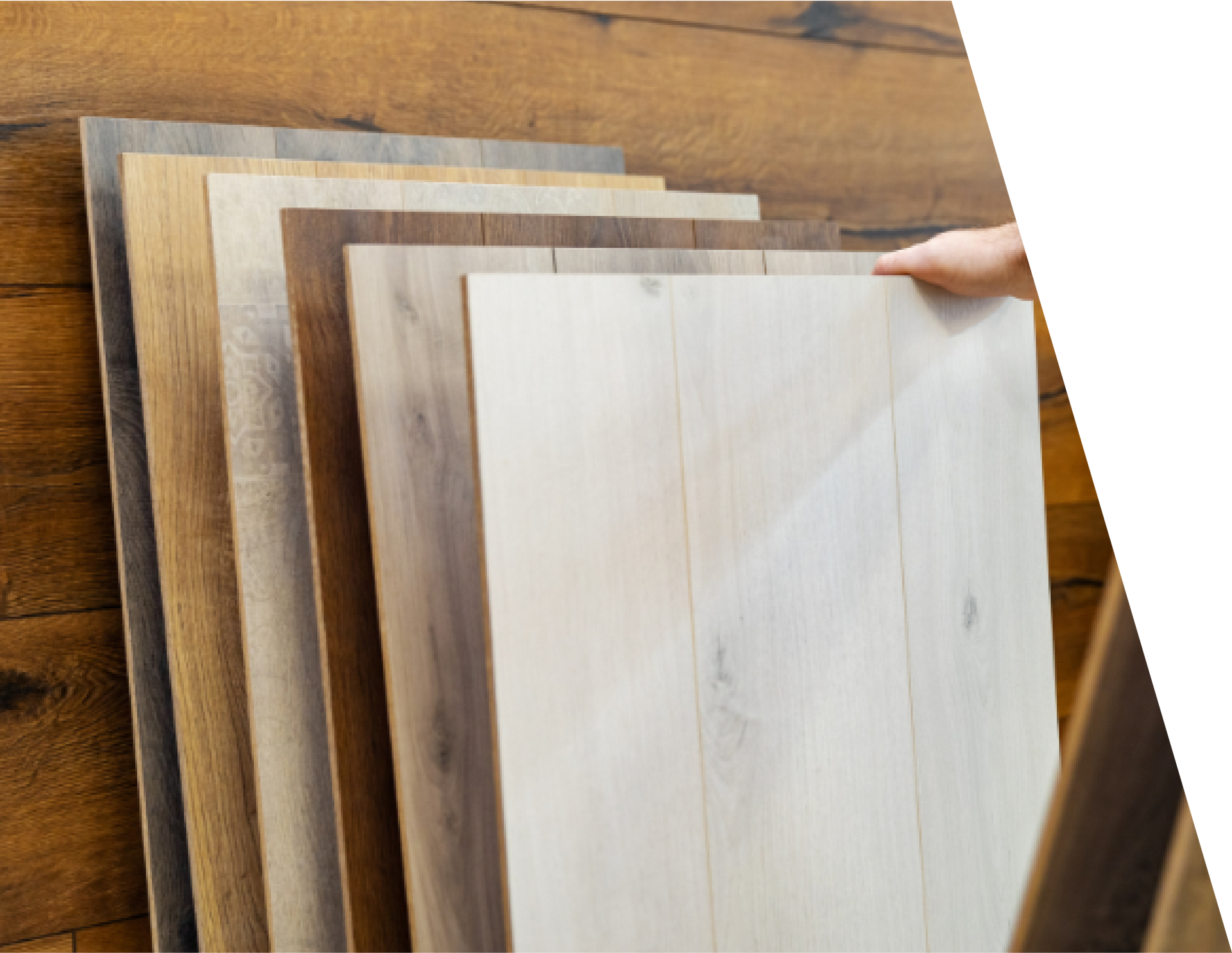 A person is pointing at a stack of wooden boards