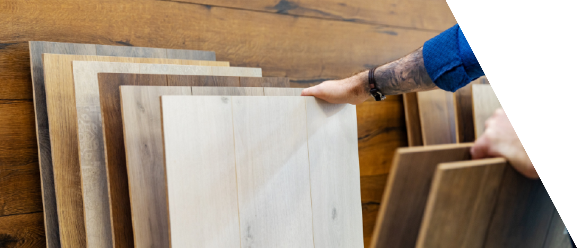 A person is pointing at a stack of wooden boards