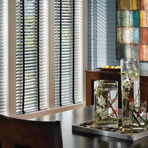 Daylight shining through window blinds into a dining room.