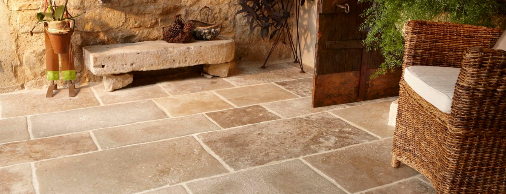Rustic outdoor living space with large, natural stone tile flooring