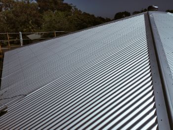 Silver Corrugated Metal Roof, Angled Perspective, Shadows, and Natural Light — Venom Roofing Pty Ltd in Sunshine Coast, QLD