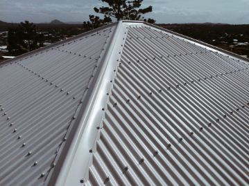 Close-up of a White Metal Roof With Many Visible Rivets. the Roof is Peaked — Venom Roofing Pty Ltd in Sunshine Coast, QLD
