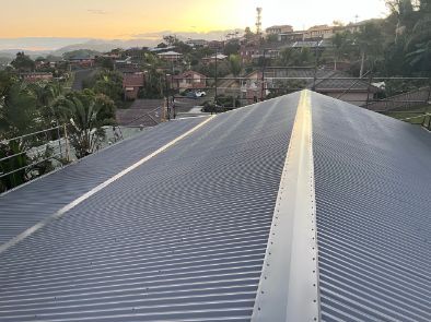 Metal Corrugated Roof With a Skyline View in the Background, Golden Hour — Venom Roofing Pty Ltd in Sunshine Coast, QLD