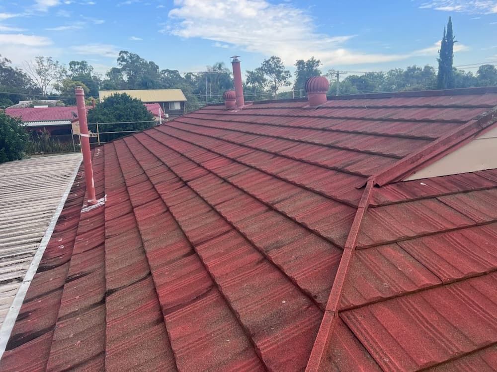 Red Tiled Roof With Chimneys and Vents — Venom Roofing Pty Ltd in Sunshine Coast, QLD