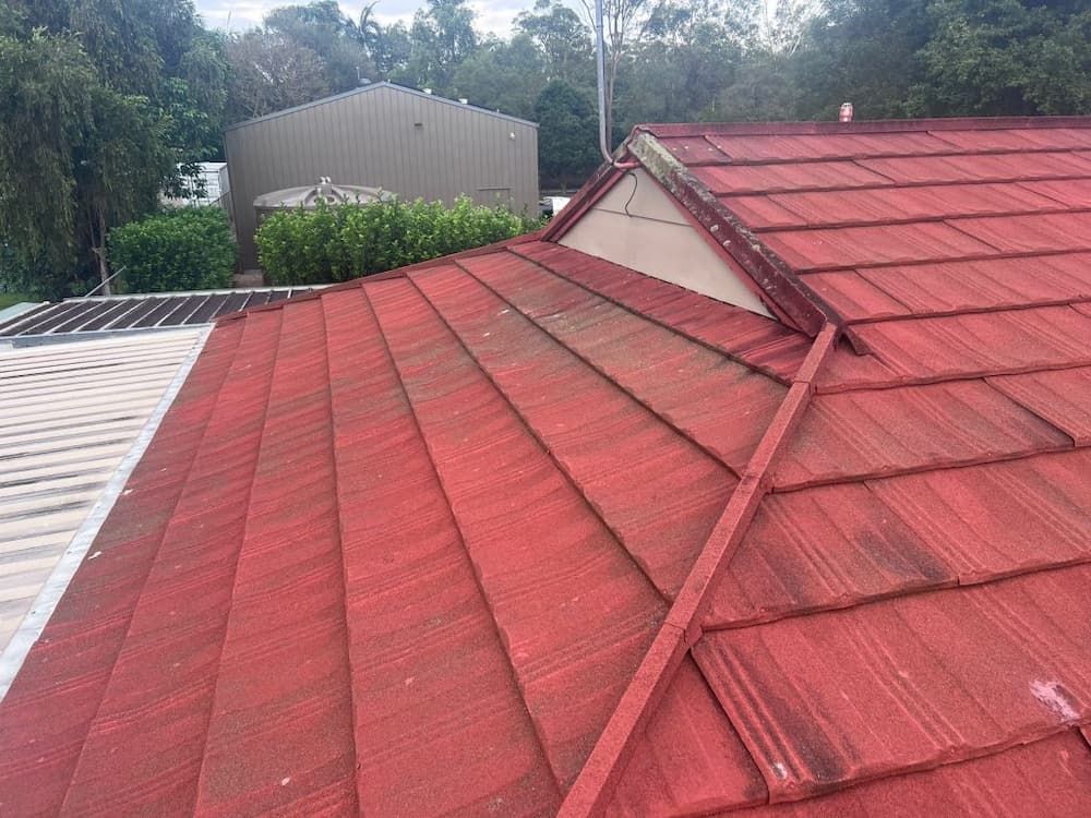 Red Tiled Roof on a House, Viewed From Above With Visible Dirt — Venom Roofing Pty Ltd in Sunshine Coast, QLD
