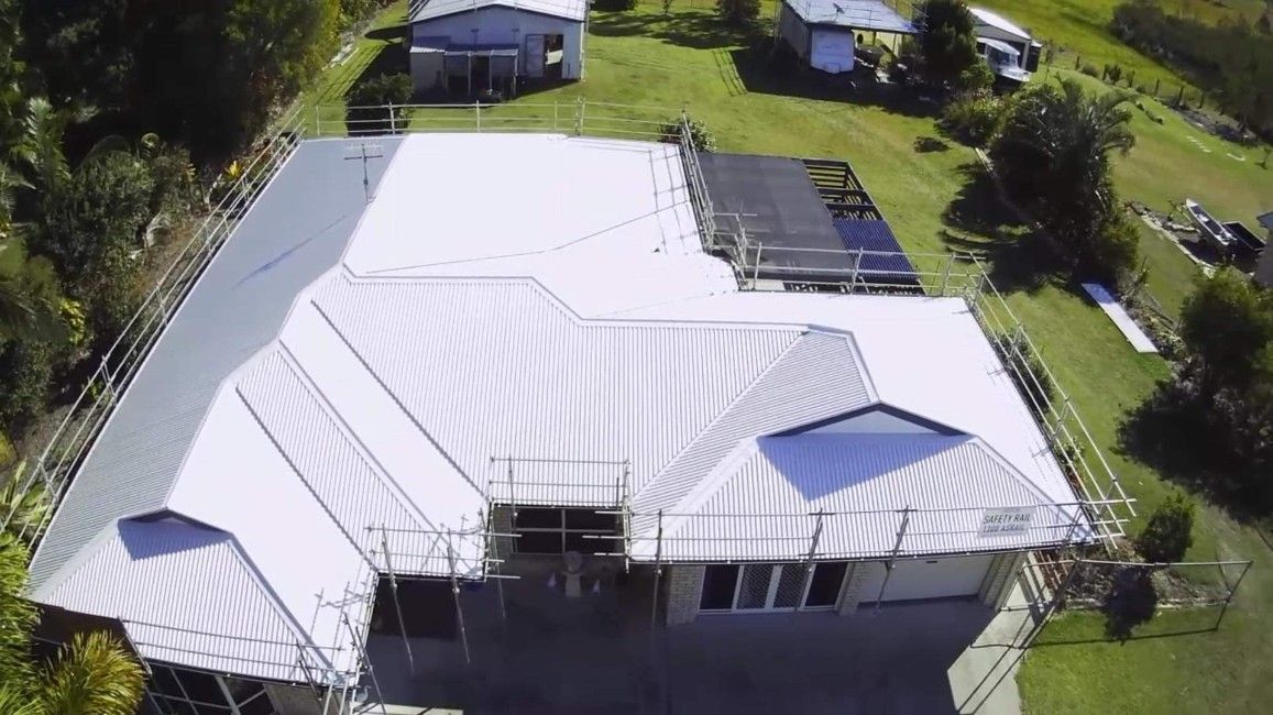Aerial View of a House With a White Metal Roof Under Construction — Venom Roofing Pty Ltd in Noosa, QLD
