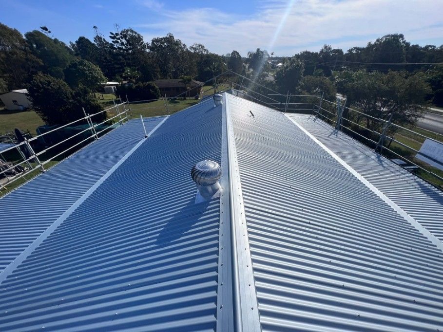 Metallic Corrugated Metal Roof With a Central Ventilation Turbine — Venom Roofing Pty Ltd in Sunshine Coast, QLD