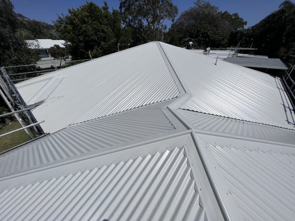White Corrugated Metal Roof of a House With Ridges and Seams — Venom Roofing Pty Ltd in Sunshine Coast, QLD