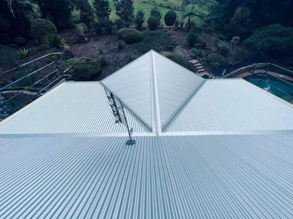 Overhead View of a Metal Roof With a Pool and Green Foliage in the Background — Venom Roofing Pty Ltd in Sunshine Coast, QLD