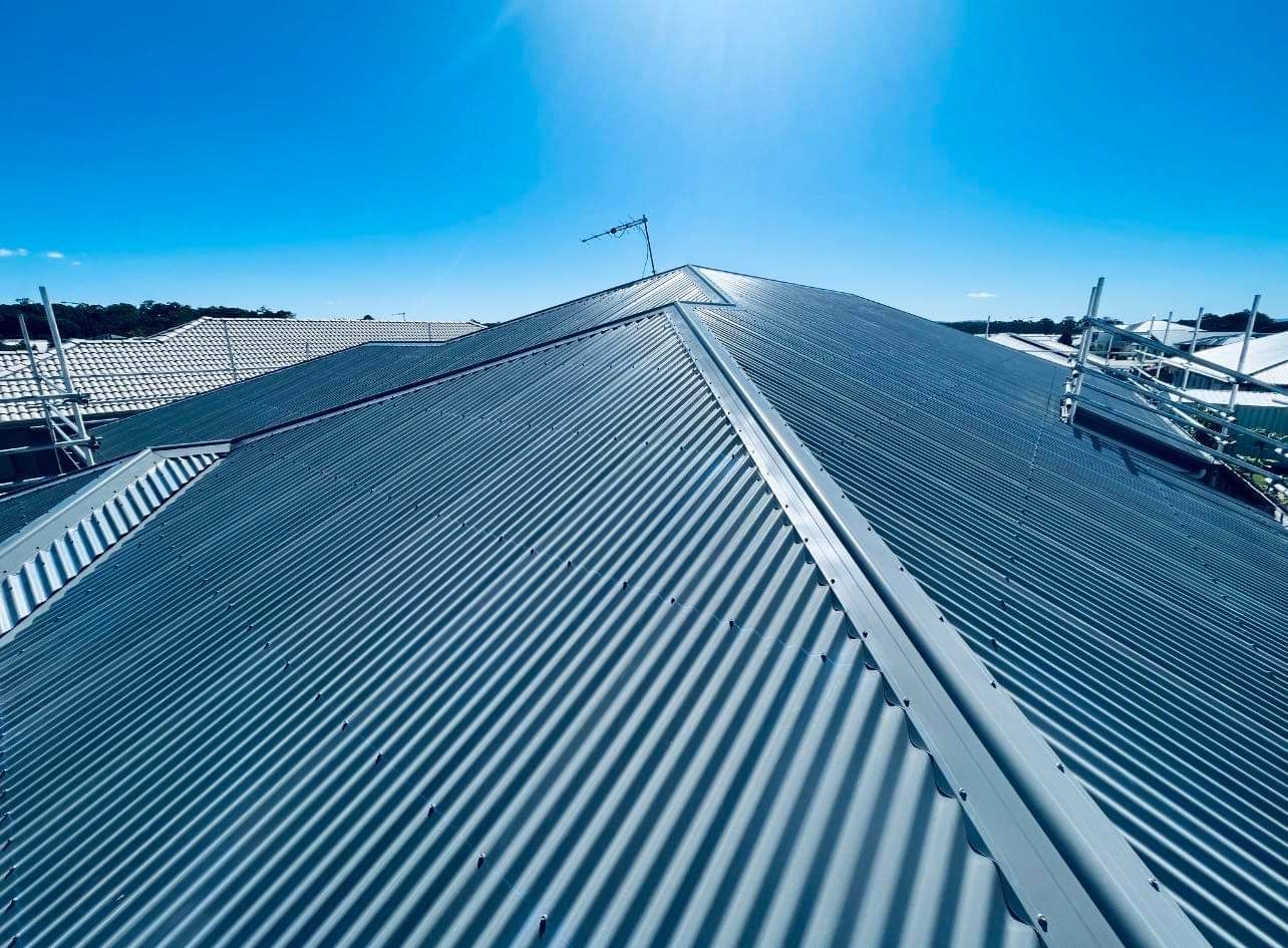 Blue Metal Corrugated Roof on a Building Under a Bright Blue Sky — Venom Roofing Pty Ltd in Sunshine Coast, QLD