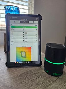 White and blue Apria Healthy Air System air purifier with power cord.