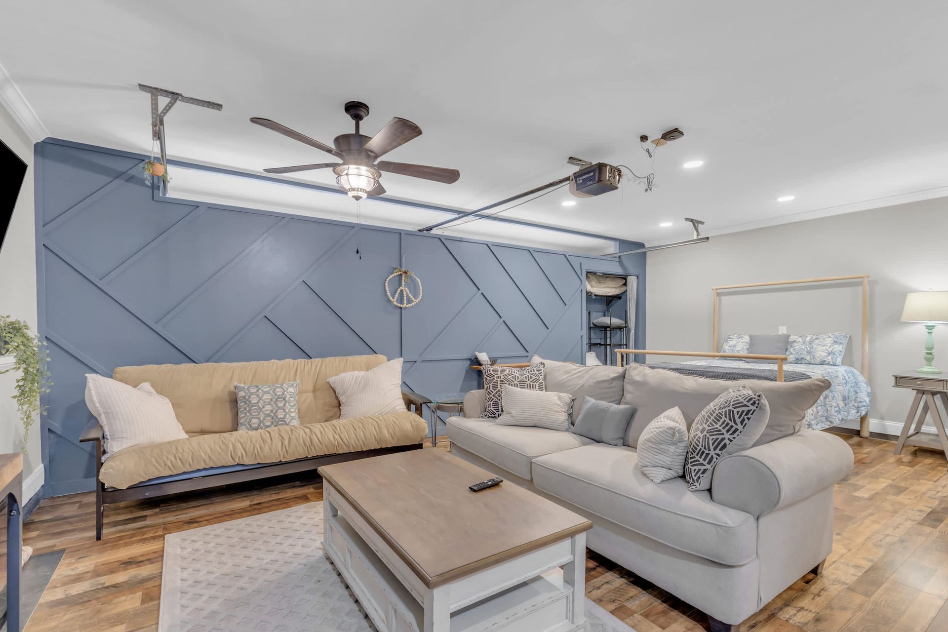 Cozy living space with a blue accent wall, two couches, and a coffee table.