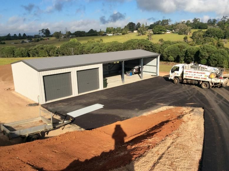A Light-Colored Metal Shed With Two Garage Doors — Bridgey's Constructions in Nowendoc, NSW