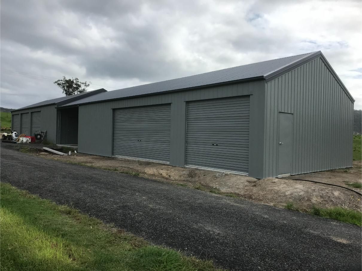 Grey Metal Shed With Three Garage Doors — Bridgey's Constructions in Gloucester, NSW