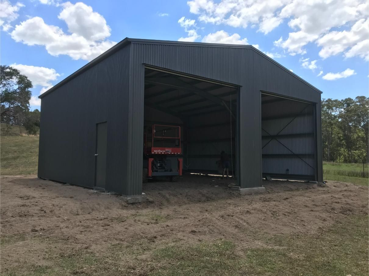 Dark Grey Metal Shed With Two Open Bays and a Single Door — Bridgey's Constructions in Wallabi Point, NSW