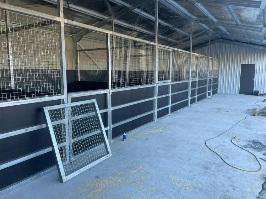 Interior of an Unfinished Horse Stable With Metal Stalls — Bridgey's Constructions in Wauchope, NSW
