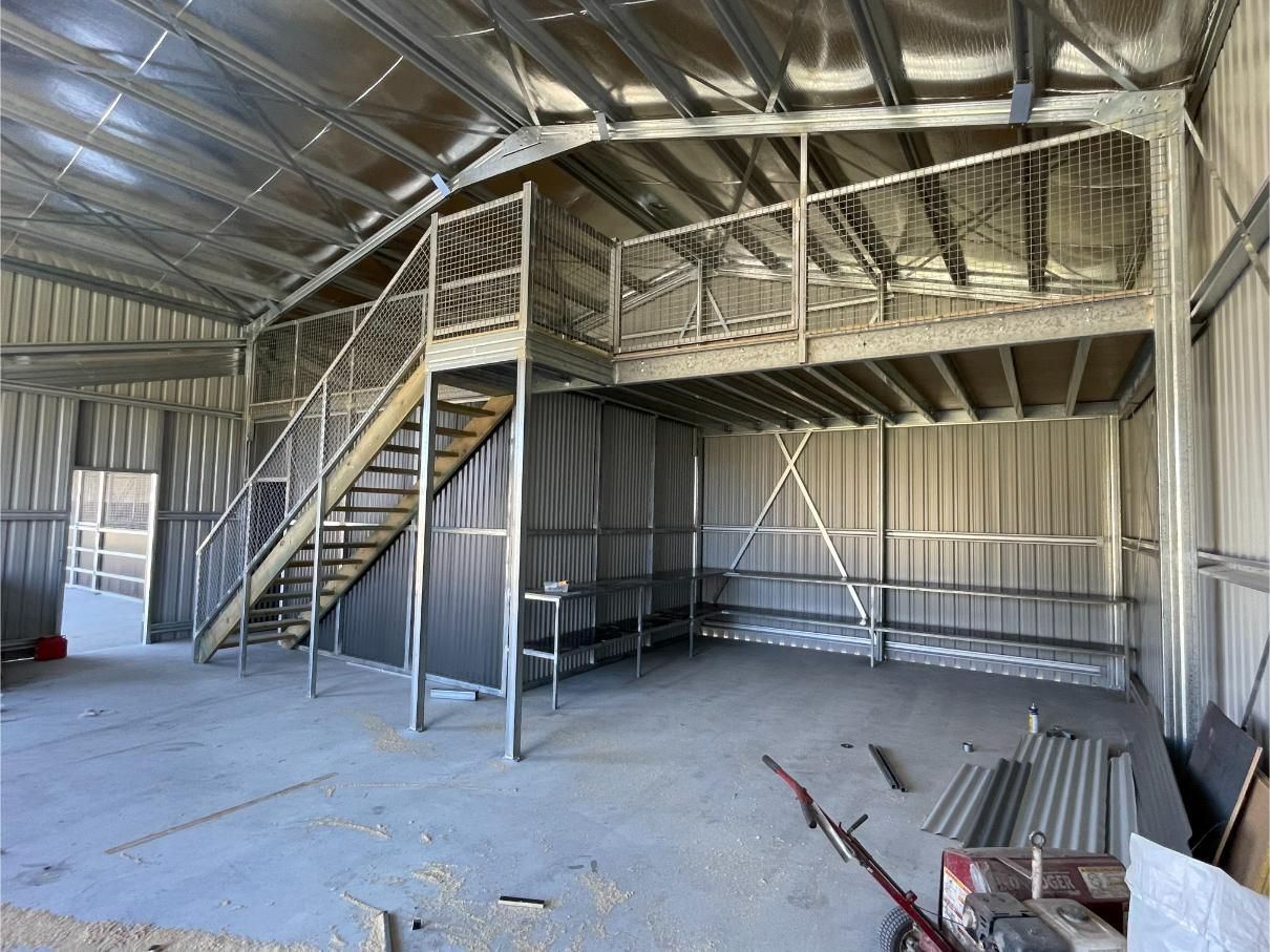 Interior of a Metal Shed With a Loft Accessible by Stairs — Bridgey's Constructions in Wingham, NSW