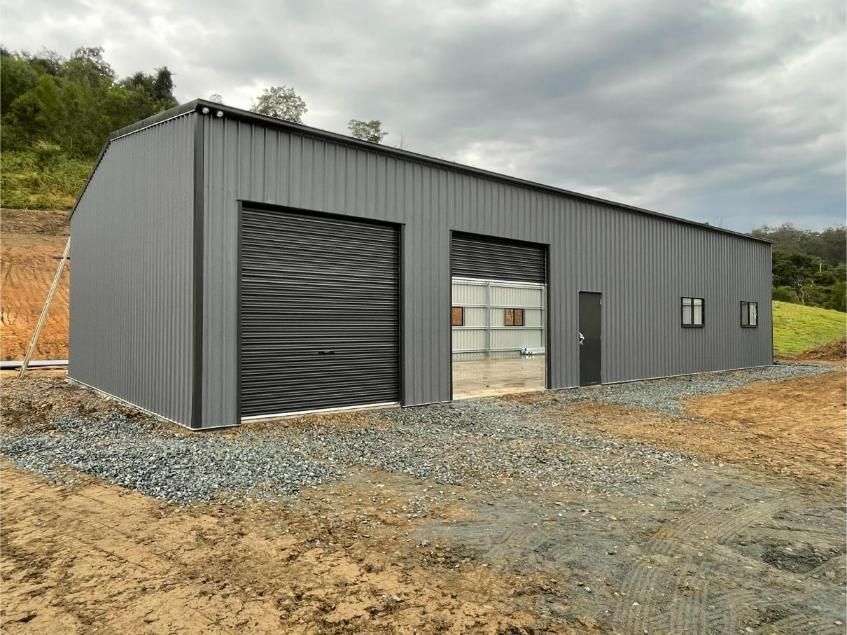 Grey Metal Building With Two Garage Doors, Small Door, and Windows — Bridgey's Constructions in Laurieton, NSW