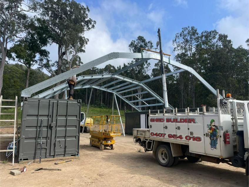 Construction Workers Assembling a Steel Arch Roof Framework Outdoors — Bridgey's Constructions in Harrington, NSW