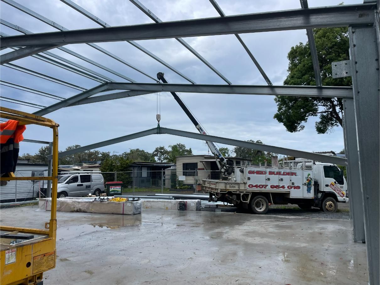 Construction Site: Steel Framework for a Building Under a Cloudy Sky — Bridgey's Constructions in Nabiac, NSW