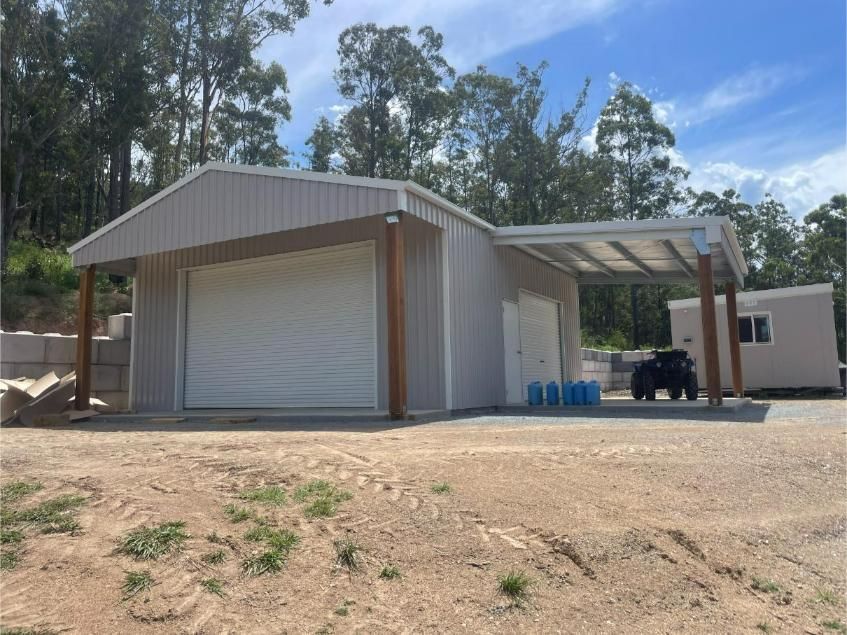Metal Building With a Large Roll-up Door, Attached Carport — Bridgey's Constructions in Taree, NSW