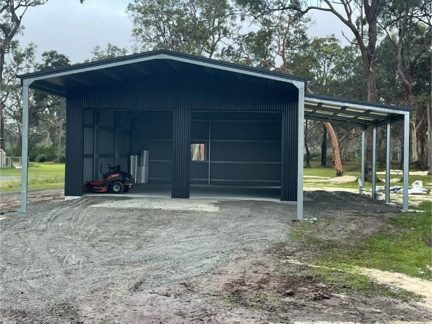 Black Metal Shed With a Carport Attached, Sitting on Gravel — Bridgey's Constructions in Nowendoc, NSW