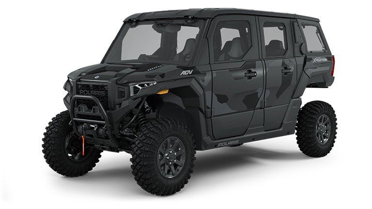 A black atv is sitting on a white surface.
