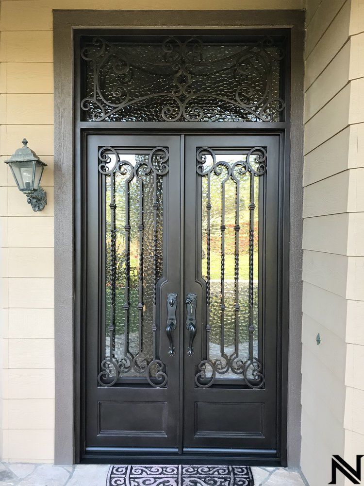 The front door of a house has a wrought iron design on it